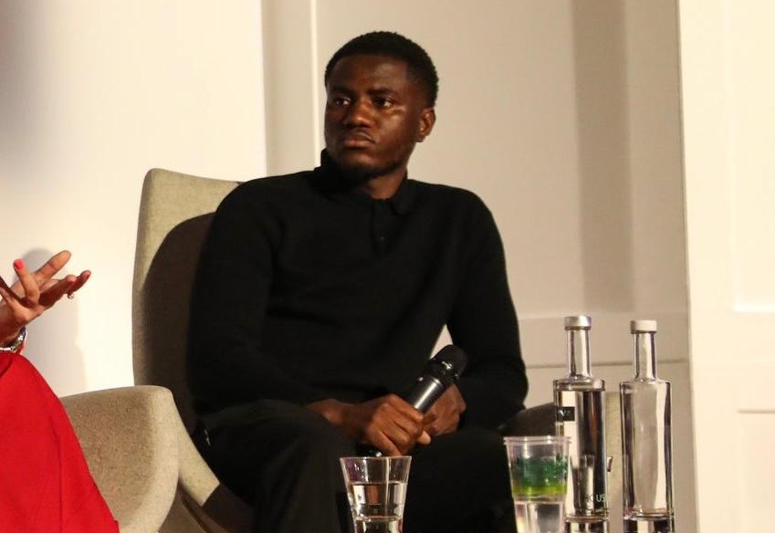 Beryly Lubala speaking at a sports conference